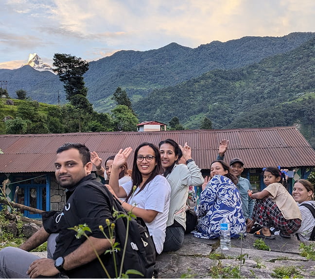 Group of nepali volunteers posing against mountain backdrop